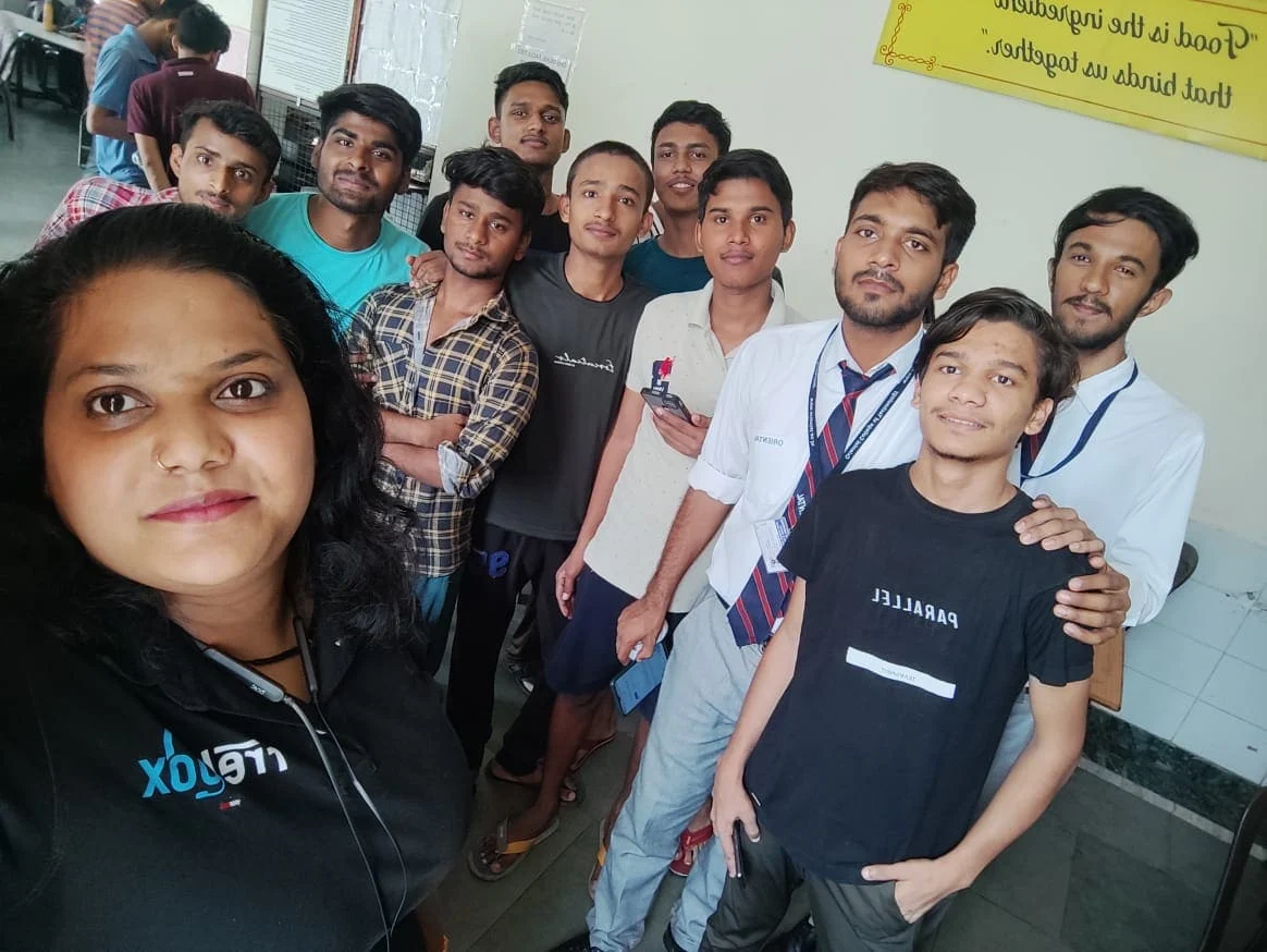 A FretBox team member with university students during a campus visit
